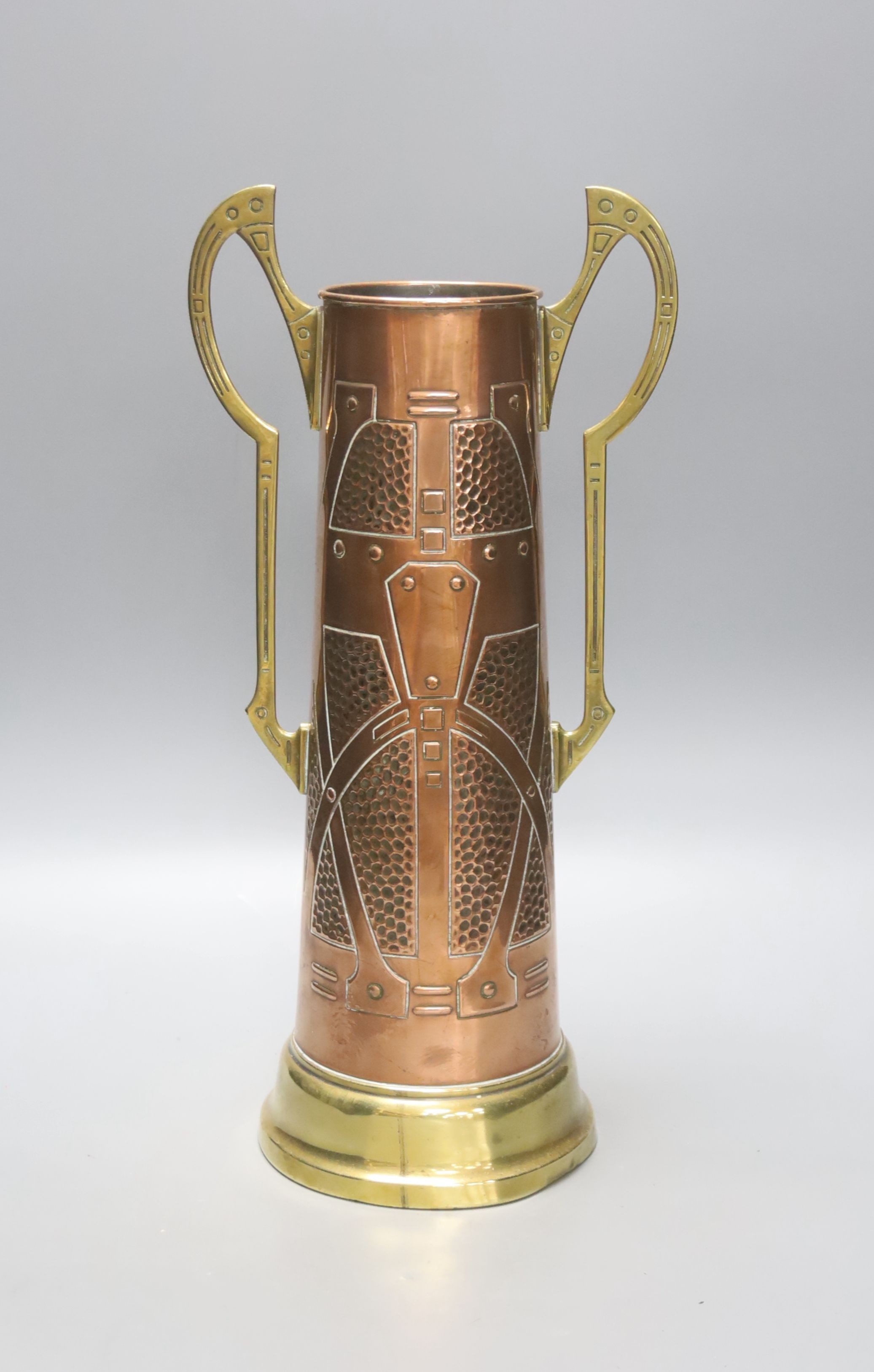 A Secessionist style copper and brass two handled cup, 40cm